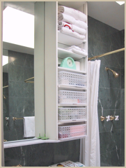 Mirrors, stone shelves and storage bins allow the powder room to function as a guest bath.