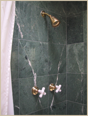 Shower taps are accented with brass fittings.