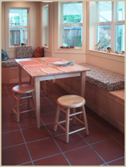 The completely re-modeled kitchen includes a comfortable seating area within the new bay window.