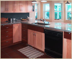 The new cabinets mix two types of wood with stone tops and a tiled backsplash.