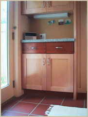 Terracotta floor tiles with wood cabinets.