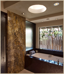 Stone separates art-glass panels at the shower area.