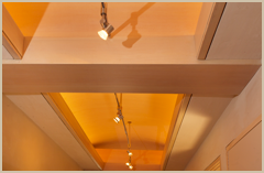 Detail at the hall coffered ceiling includes wood and plaster with special lighting.