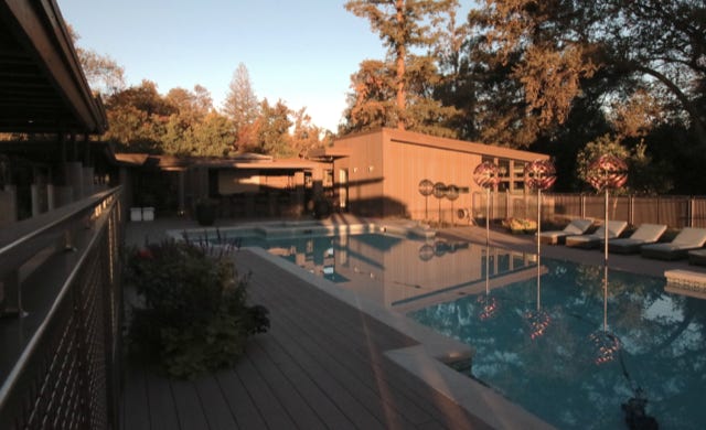 pool view from residence with pool house beyond