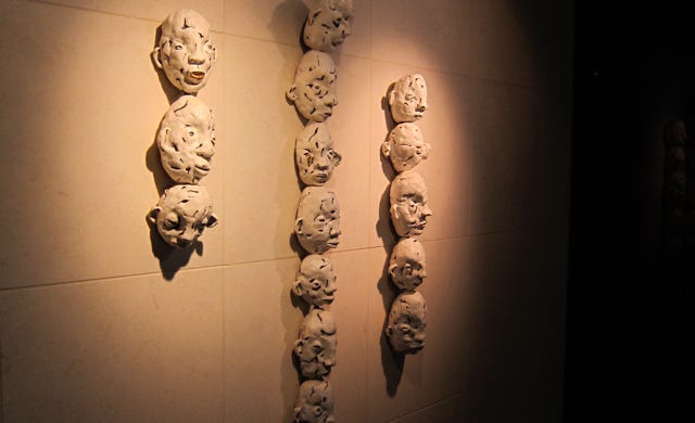 sculpture on bathroom wall